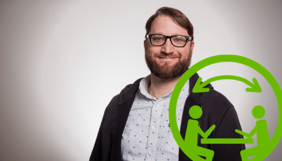 Photo of a young man with a beard and wearing glasses. A green icon with two stick dolls seated and chatting.